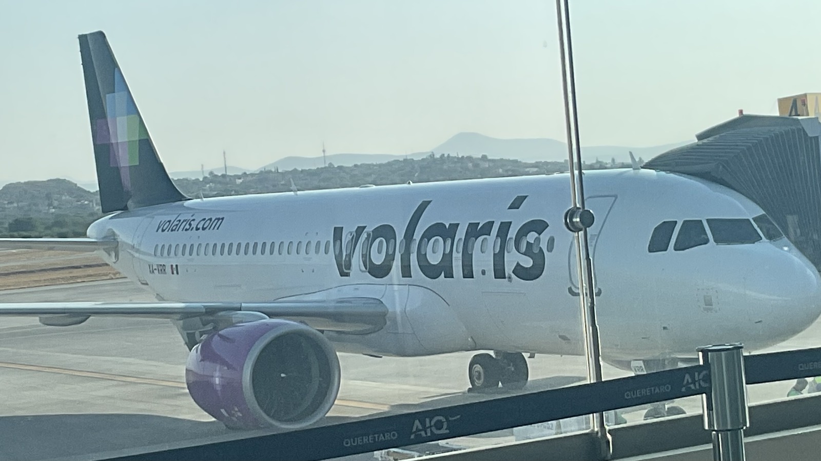 Volaris Airbus A321neo aircraft in Volaris livery parked at an airport gate