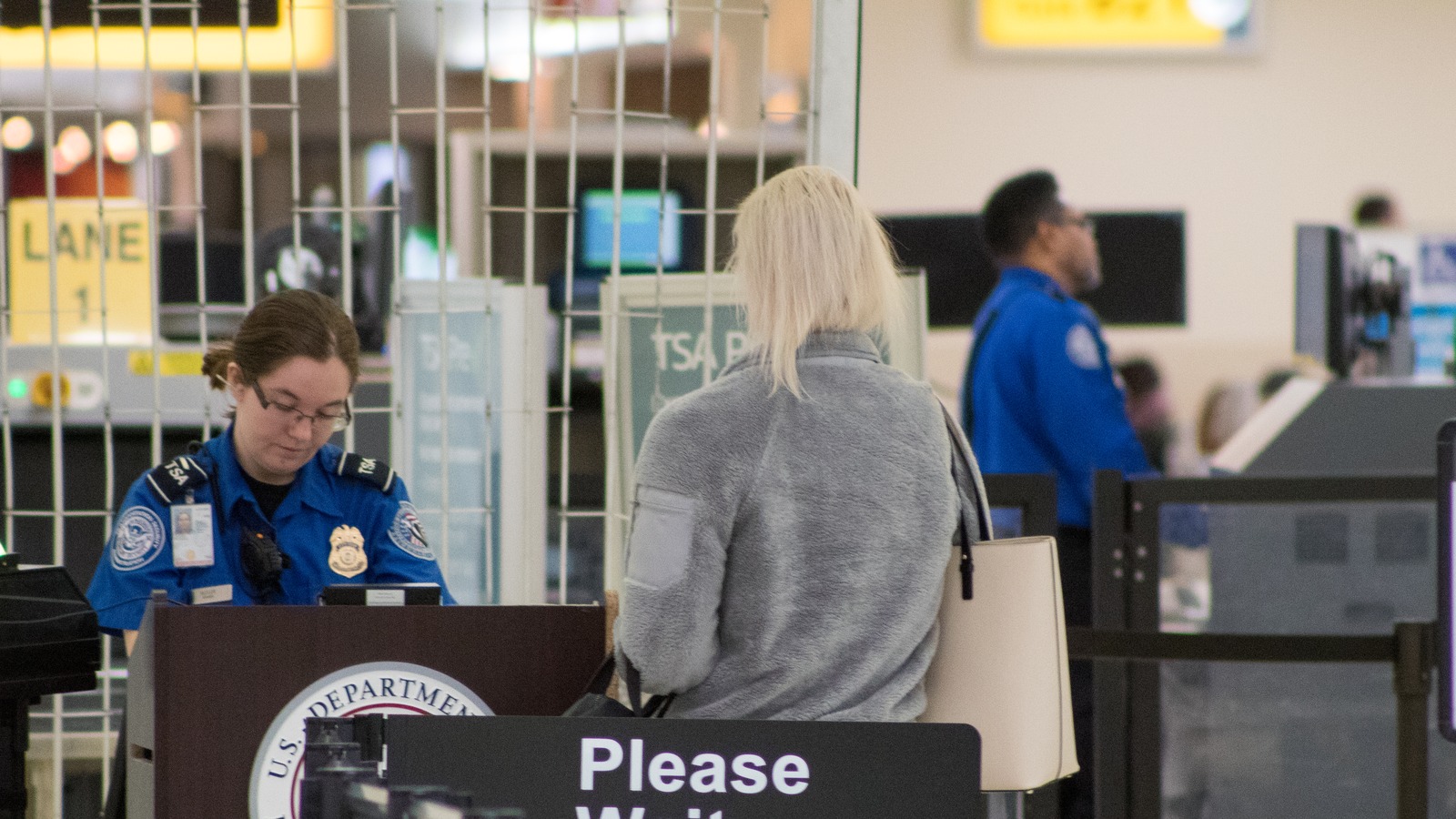 A Transportation Security Administration officer checks identification at a checkpoint at John Glenn Columbus International Airport.