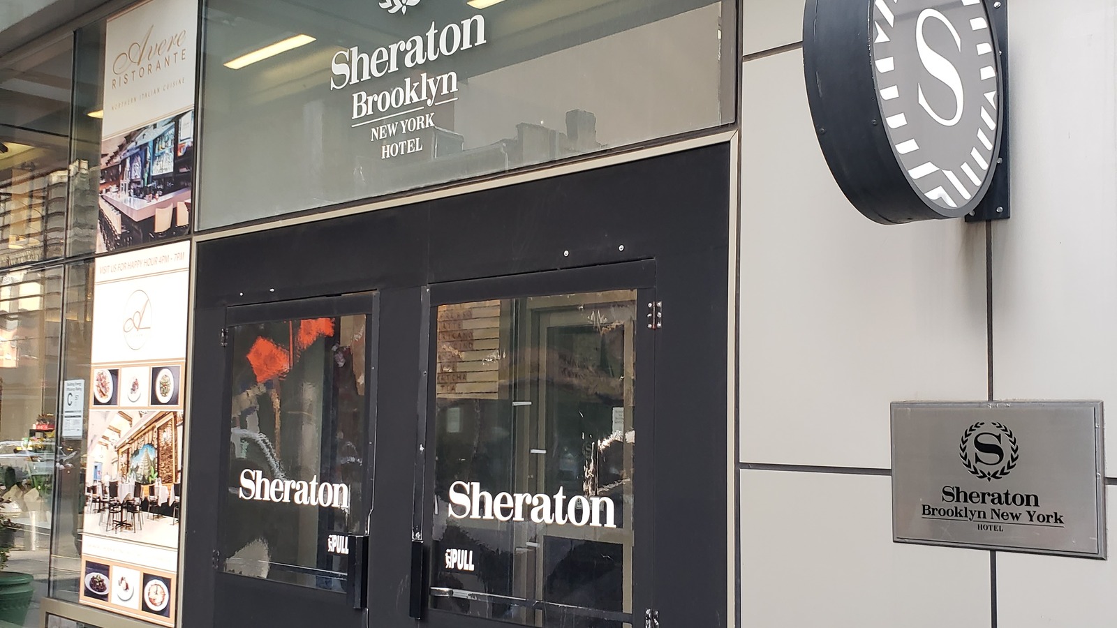 Entrance doors, awning sign and street-level signage of the Sheraton Brooklyn New York Hotel