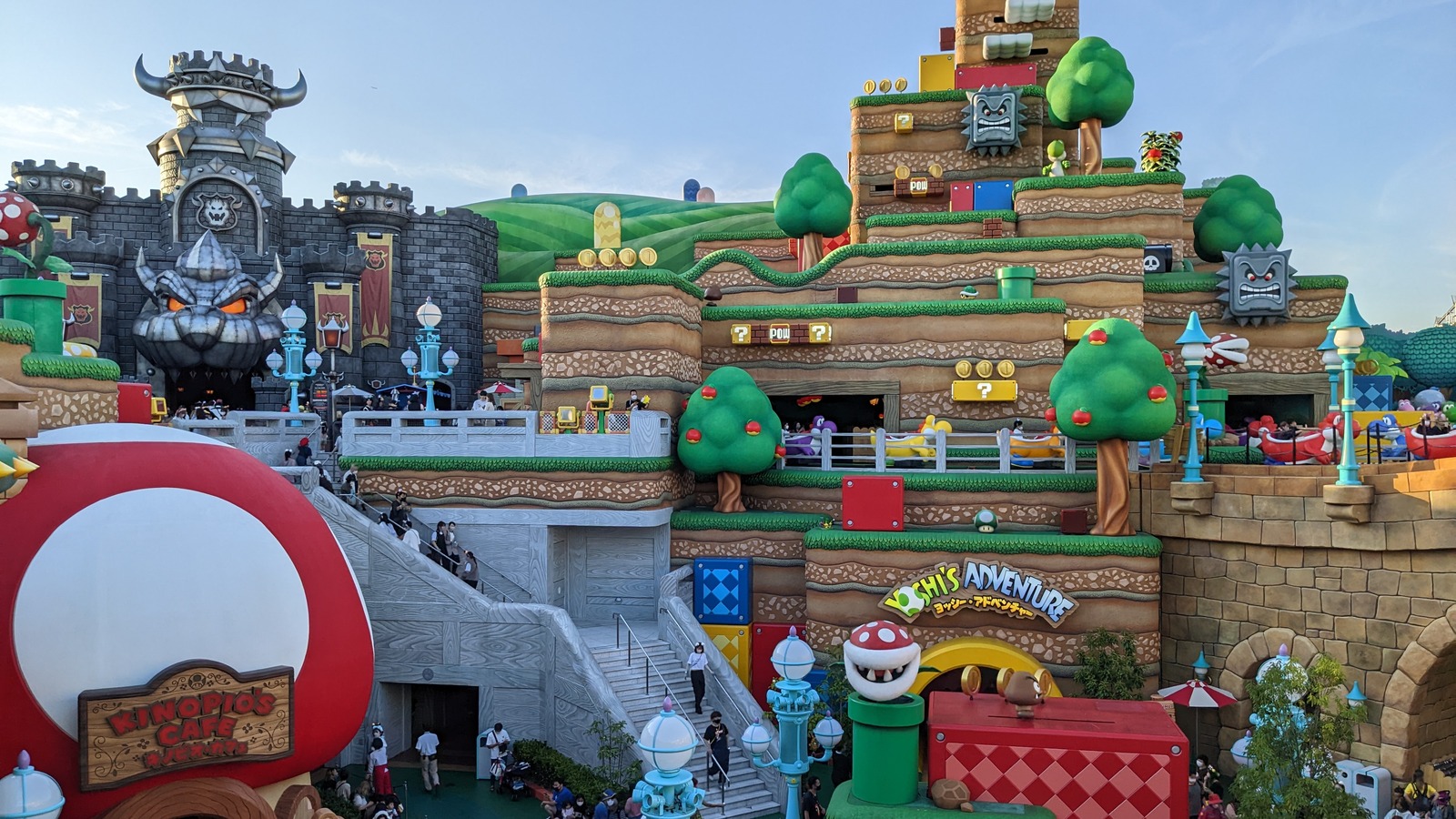 Overview of the Super Nintendo World area at Universal Studios Japan in Osaka, with Bowser's castle on the left and the Yoshi's Adventure entrance on the right