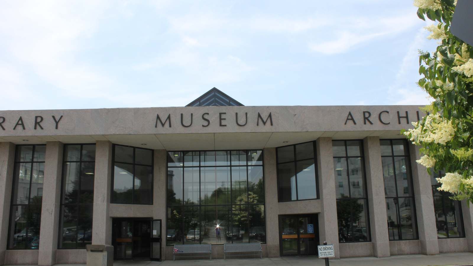 Granite facade of the Maine State Library, Museum and Archives building in Augusta with MUSEUM lettered above a glass entrance.
