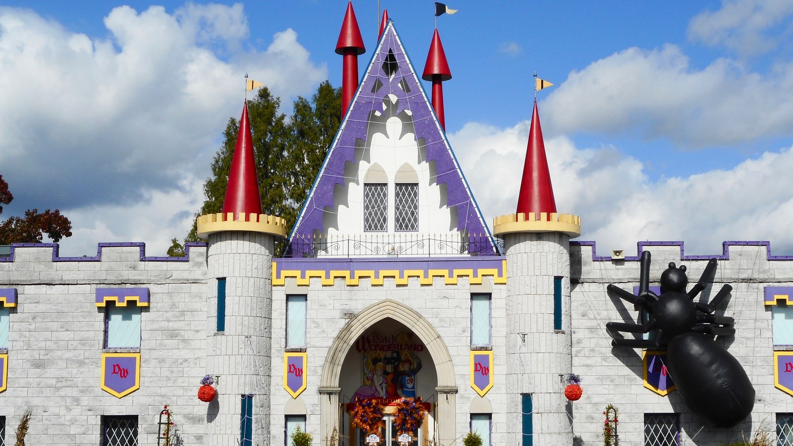 The Dutch Wonderland castle entrance in Lancaster, Pennsylvania decorated for Halloween with a large inflatable spider and webbing