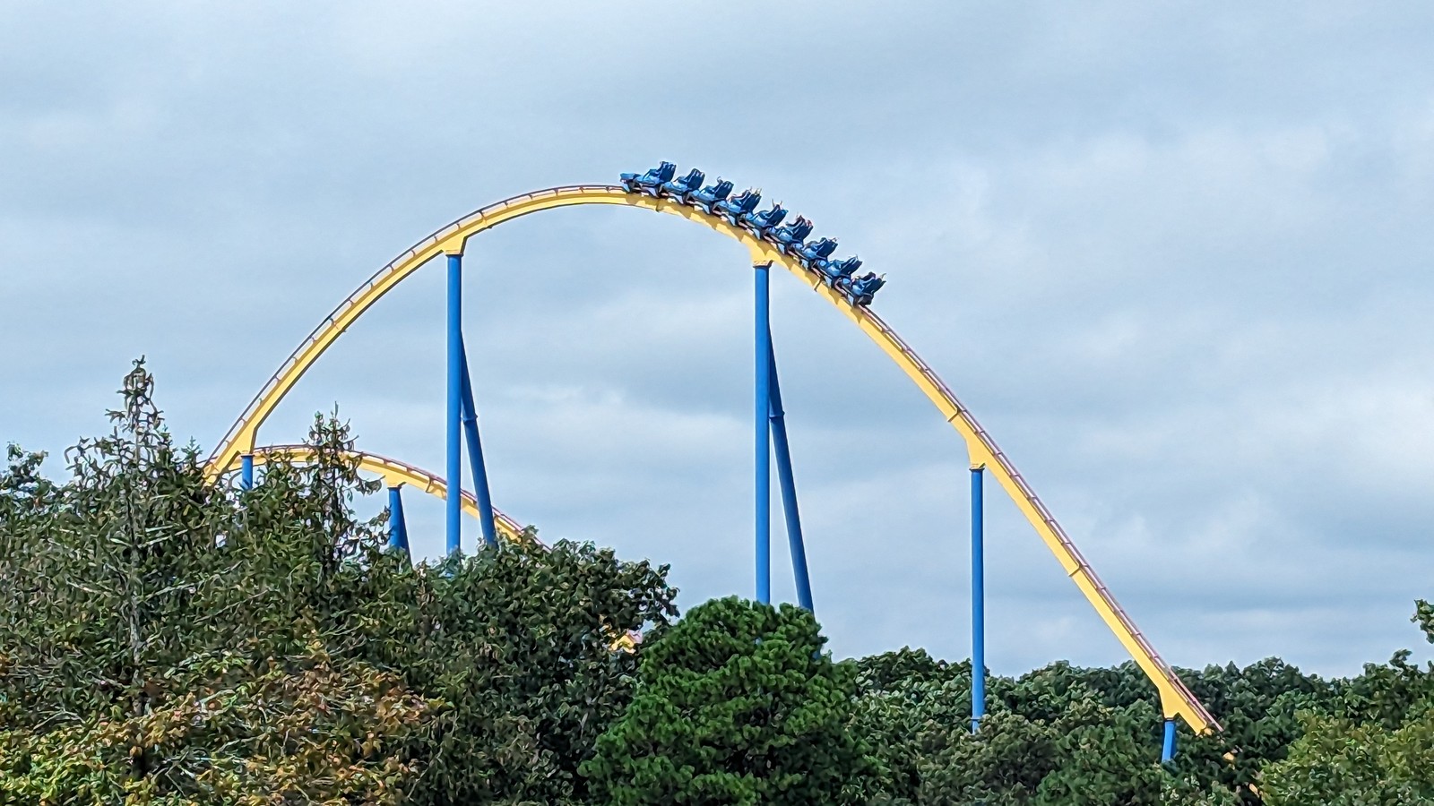 Nitro coaster train cresting a yellow hill at Six Flags Great Adventure