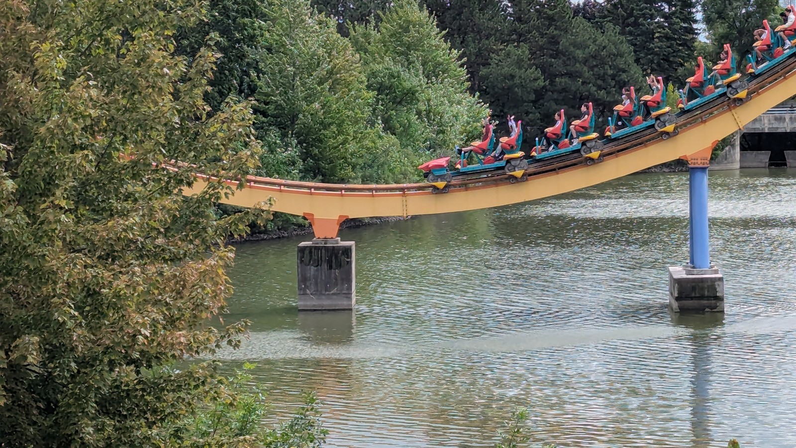 Behemoth coaster train moving over the water at Canada's Wonderland