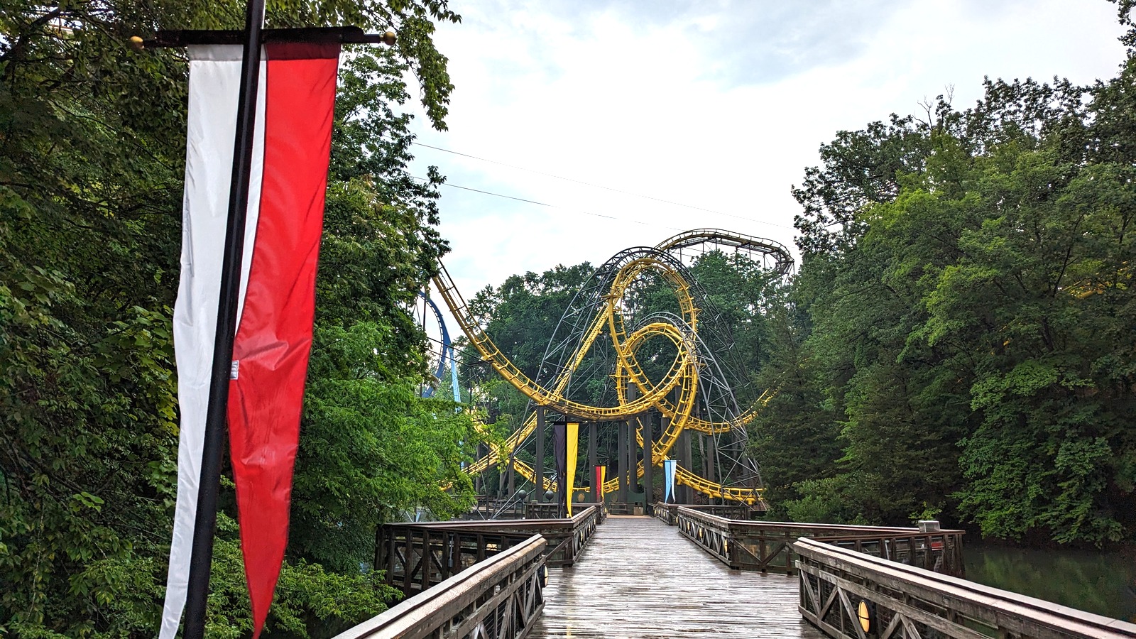 Loch Ness Monster interlocking loops beyond a wet bridge at Busch Gardens Williamsburg