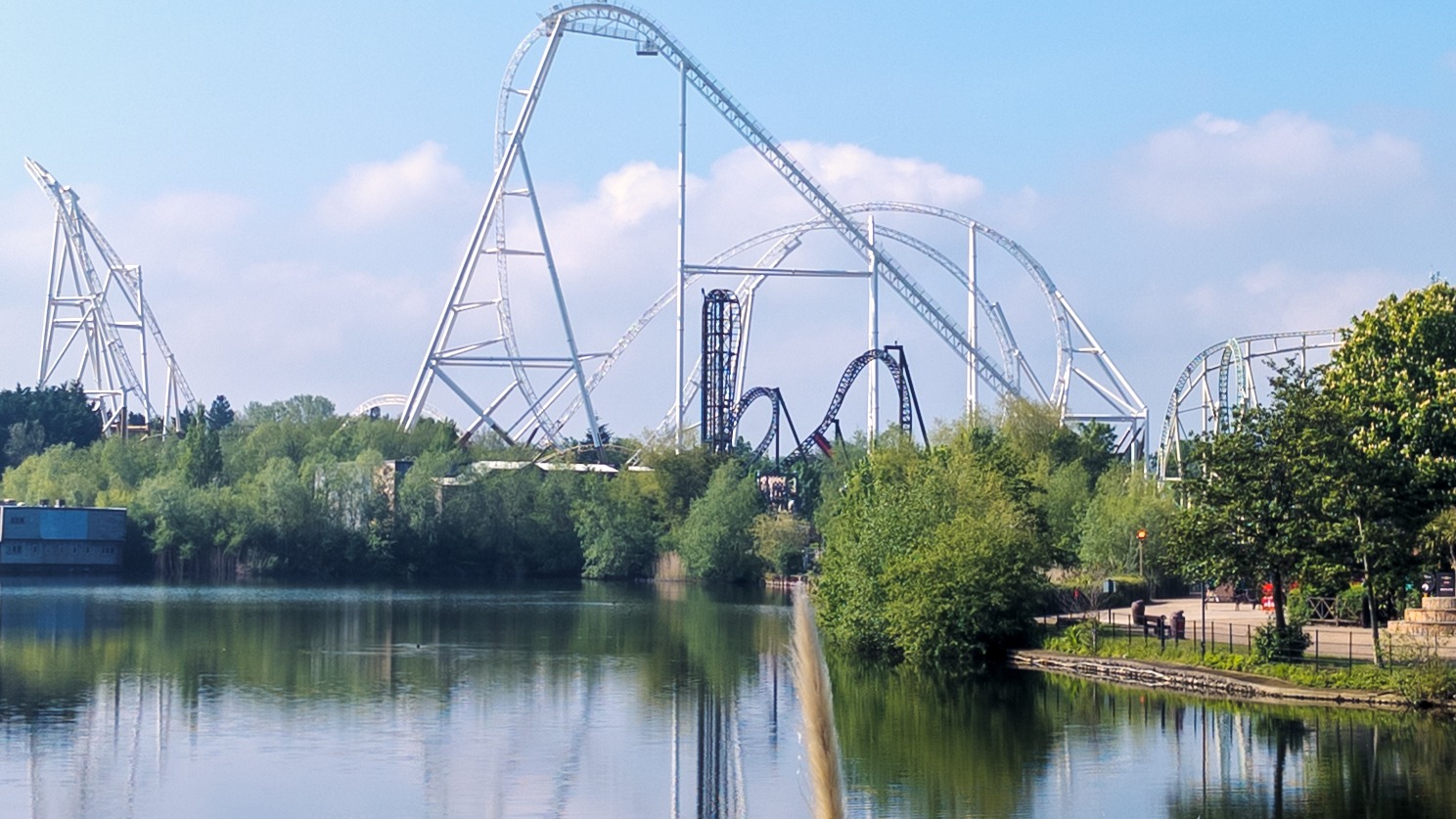 Hyperia and Saw roller coaster tracks across the lake at Thorpe Park
