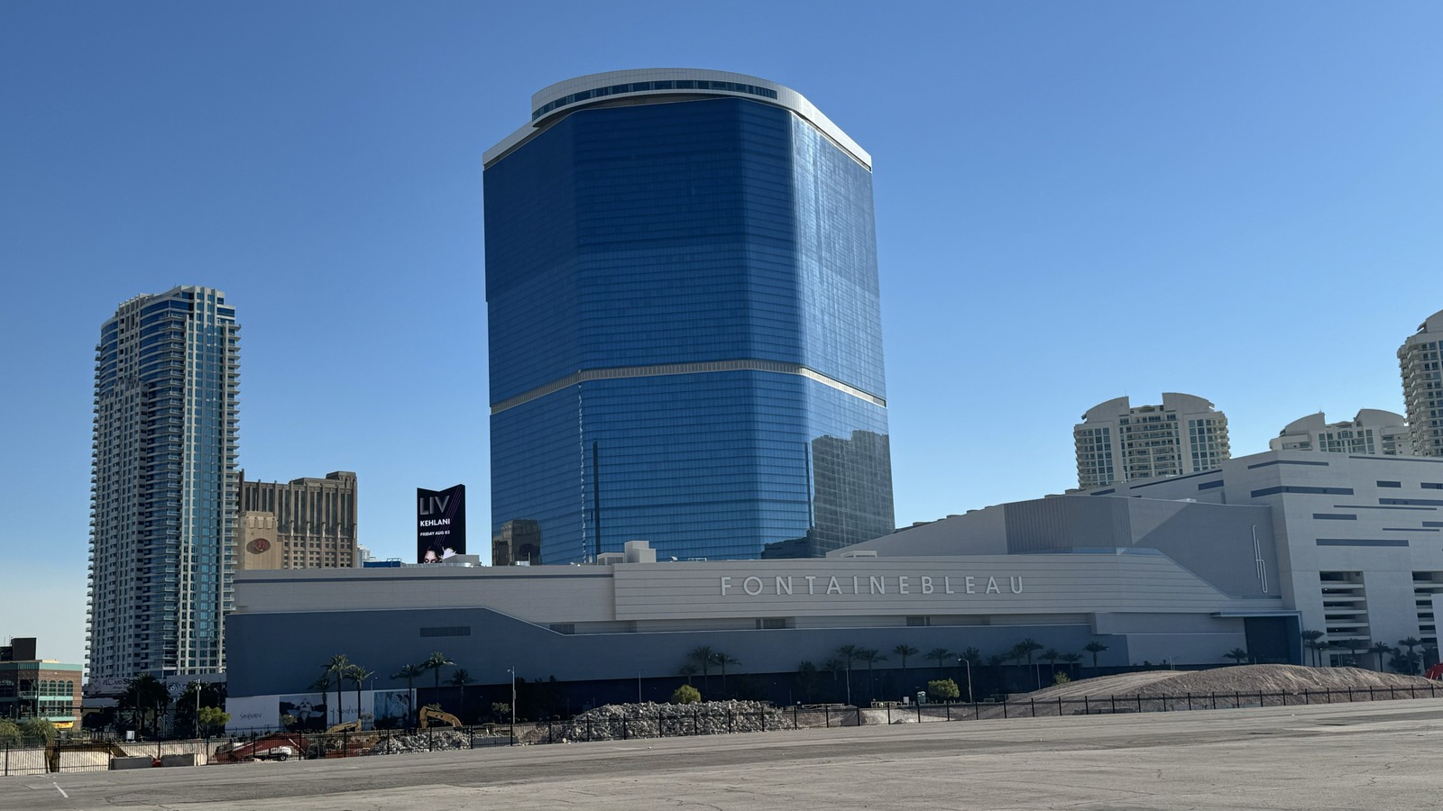 Daytime exterior of Fontainebleau Las Vegas, with the resort name visible on the low facade and the main tower behind it.