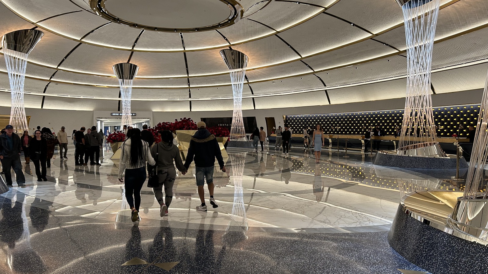 The illuminated Fontainebleau Las Vegas lobby, showing its circular ceiling, sculptural columns and reception area.