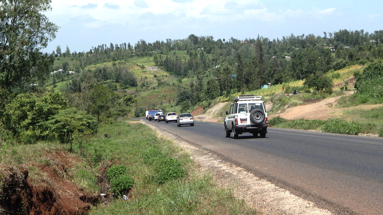 Car stopped beside a mountain road on a long-distance trip