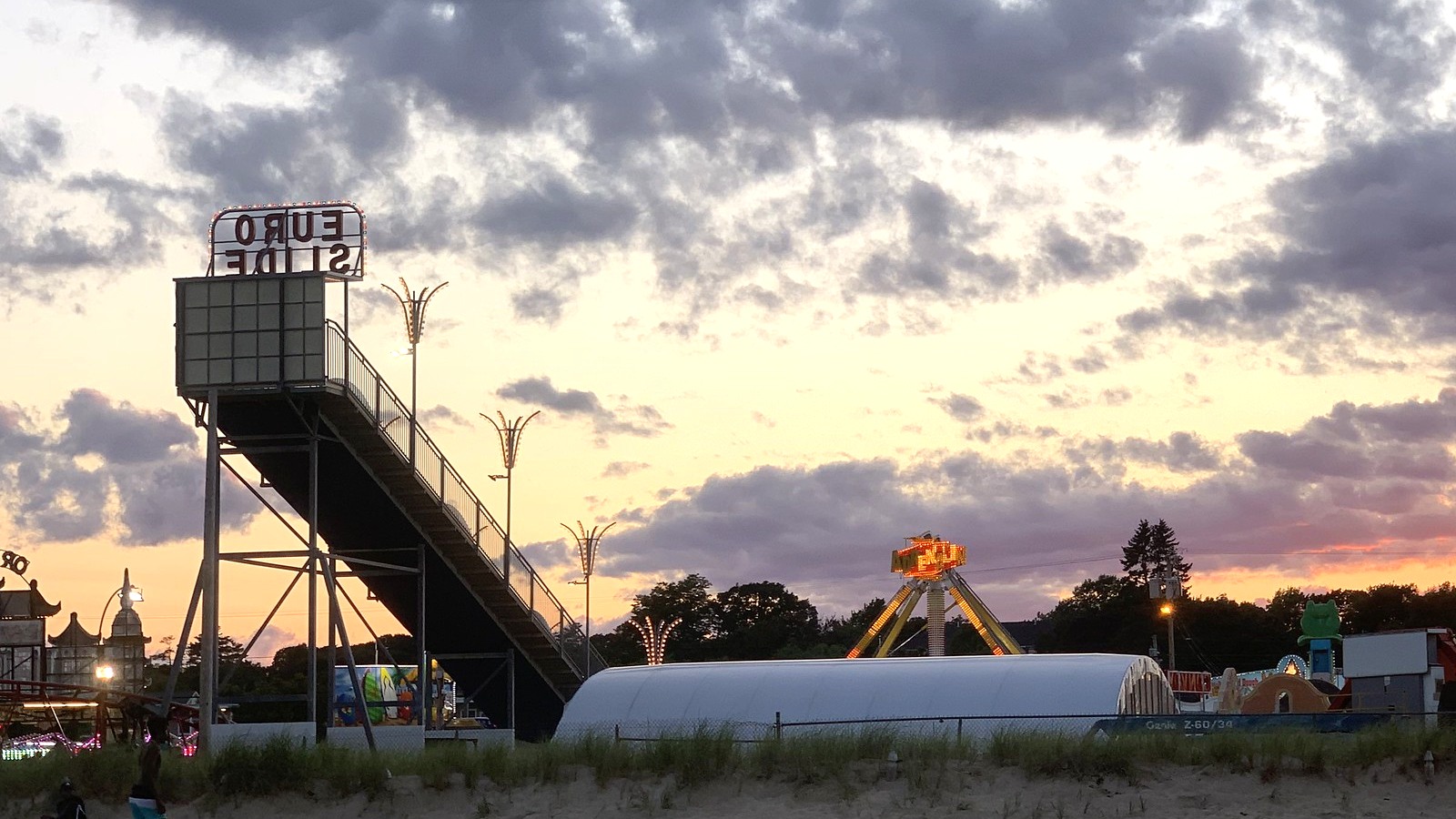 Back staircase and Euro Slide sign above the beachfront ride skyline at Palace Playland