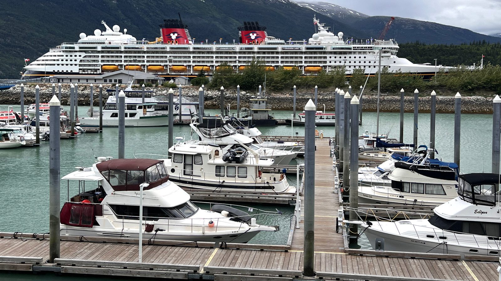 Cruise ship in Skagway harbor with mountains behind the waterfront