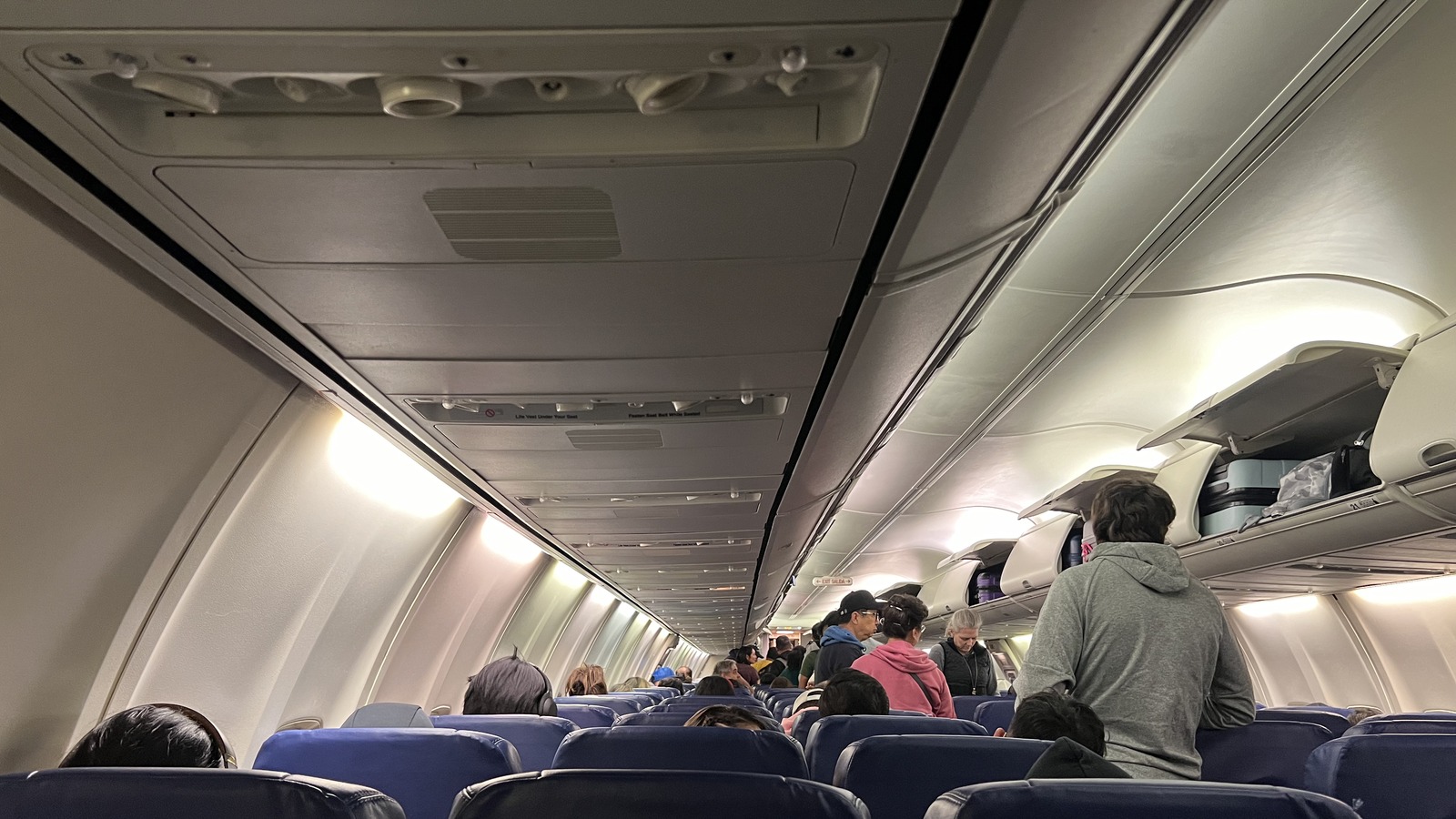 Blue seats and overhead bins in a Southwest cabin photographed in October 2023