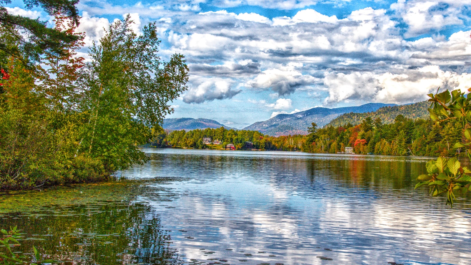 Mirror Lake reflecting Adirondack mountains beside Lake Placid village