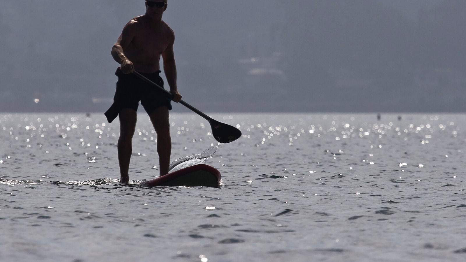 Paddleboarder crossing the protected Morro Bay estuary