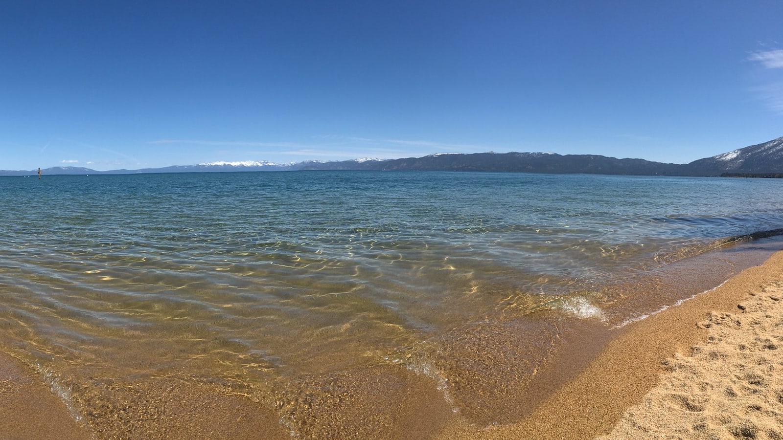 Sandy shoreline and clear water at Pope Beach