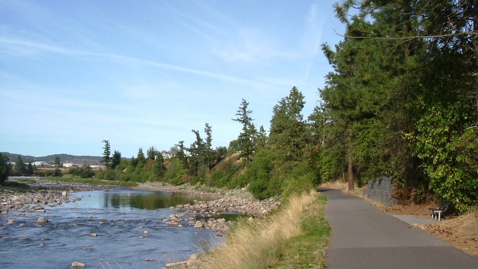 Paved Spokane River Centennial Trail beside the river in Washington