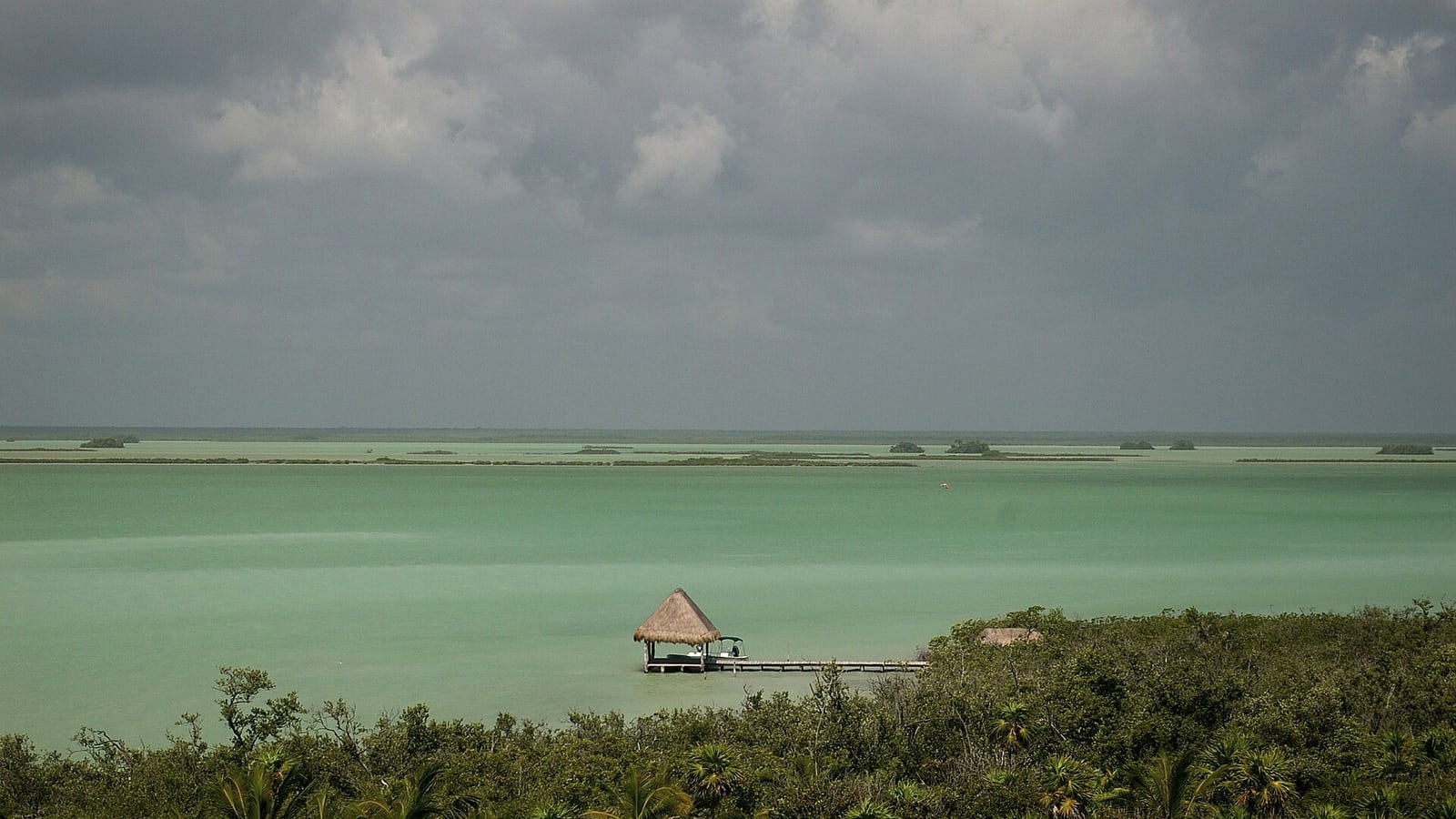Small boat crossing a mangrove lagoon in the Sian Ka'an Biosphere Reserve near Tulum Mexico