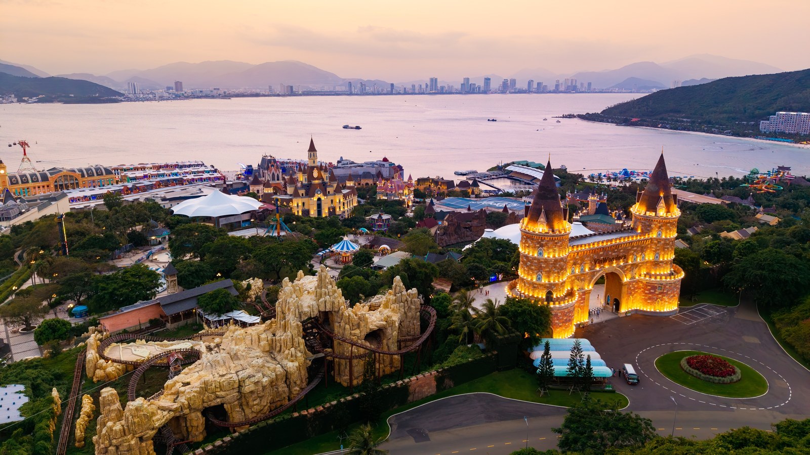 Illuminated castle and rocky coaster at VinWonders Nha Trang above the bay
