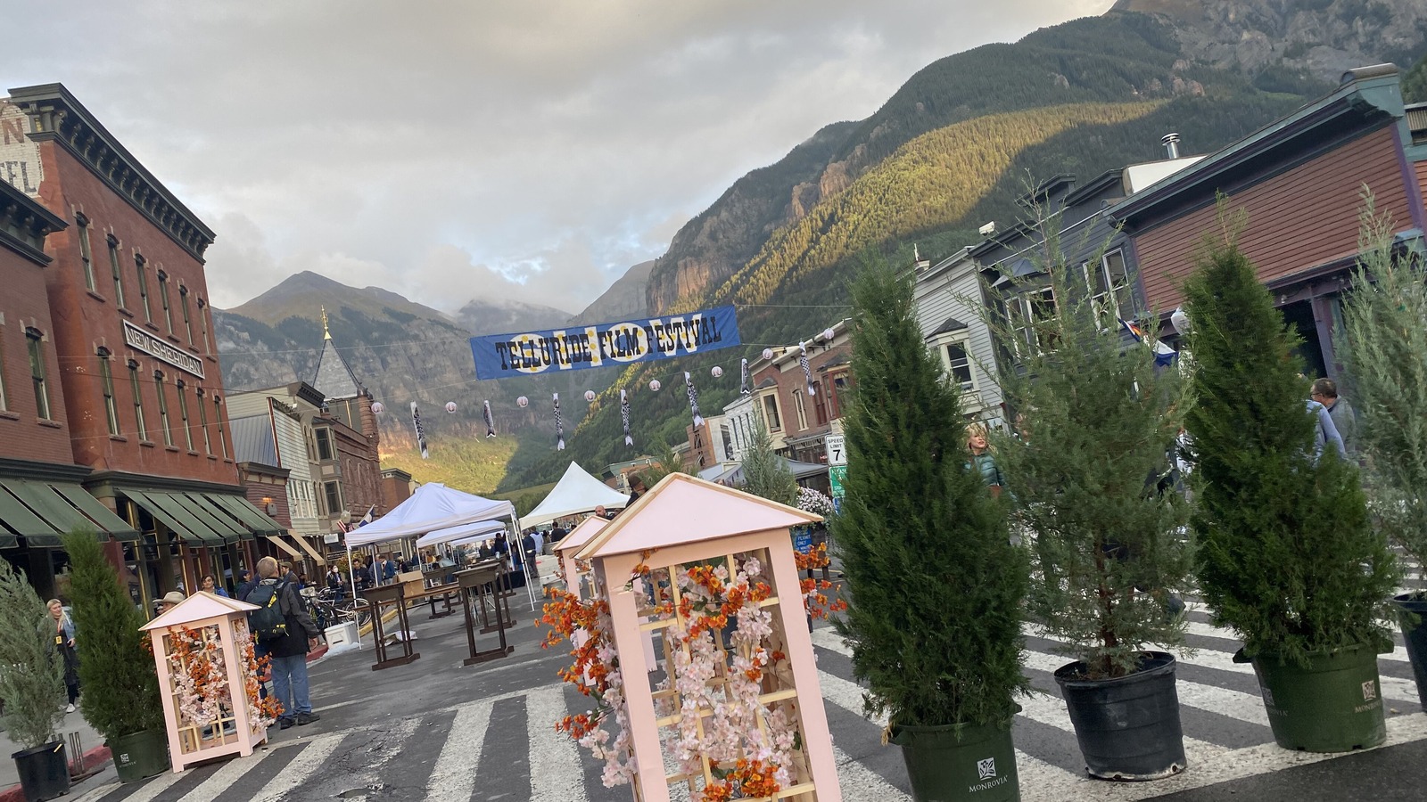 Sunny Main Street in historic Telluride with mountains behind town