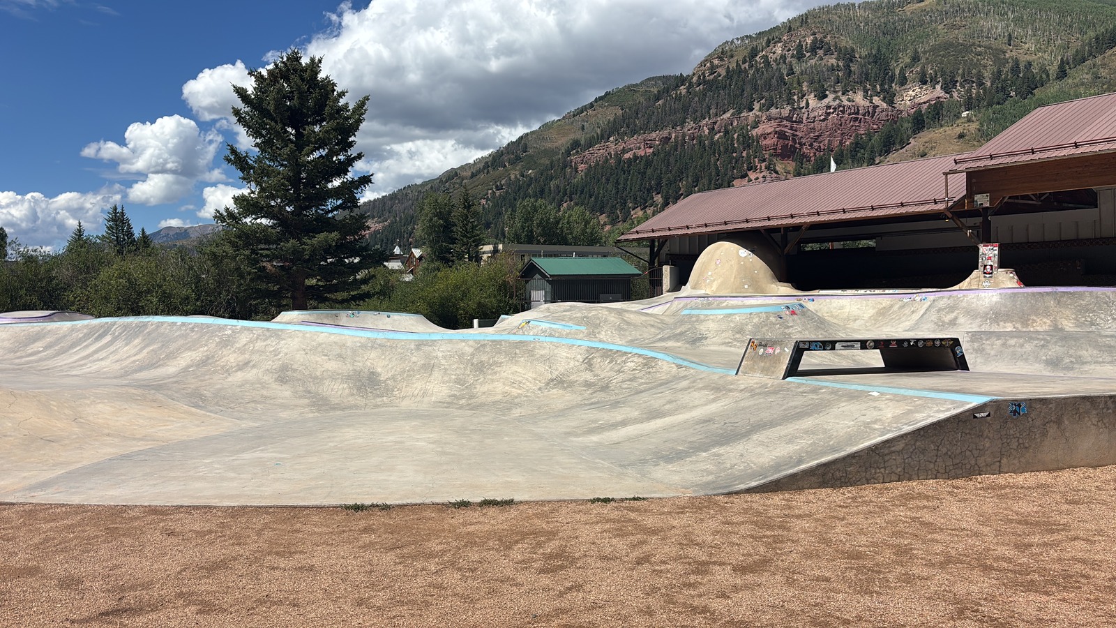 Sunny summer view of Telluride Town Park beneath mountain peaks