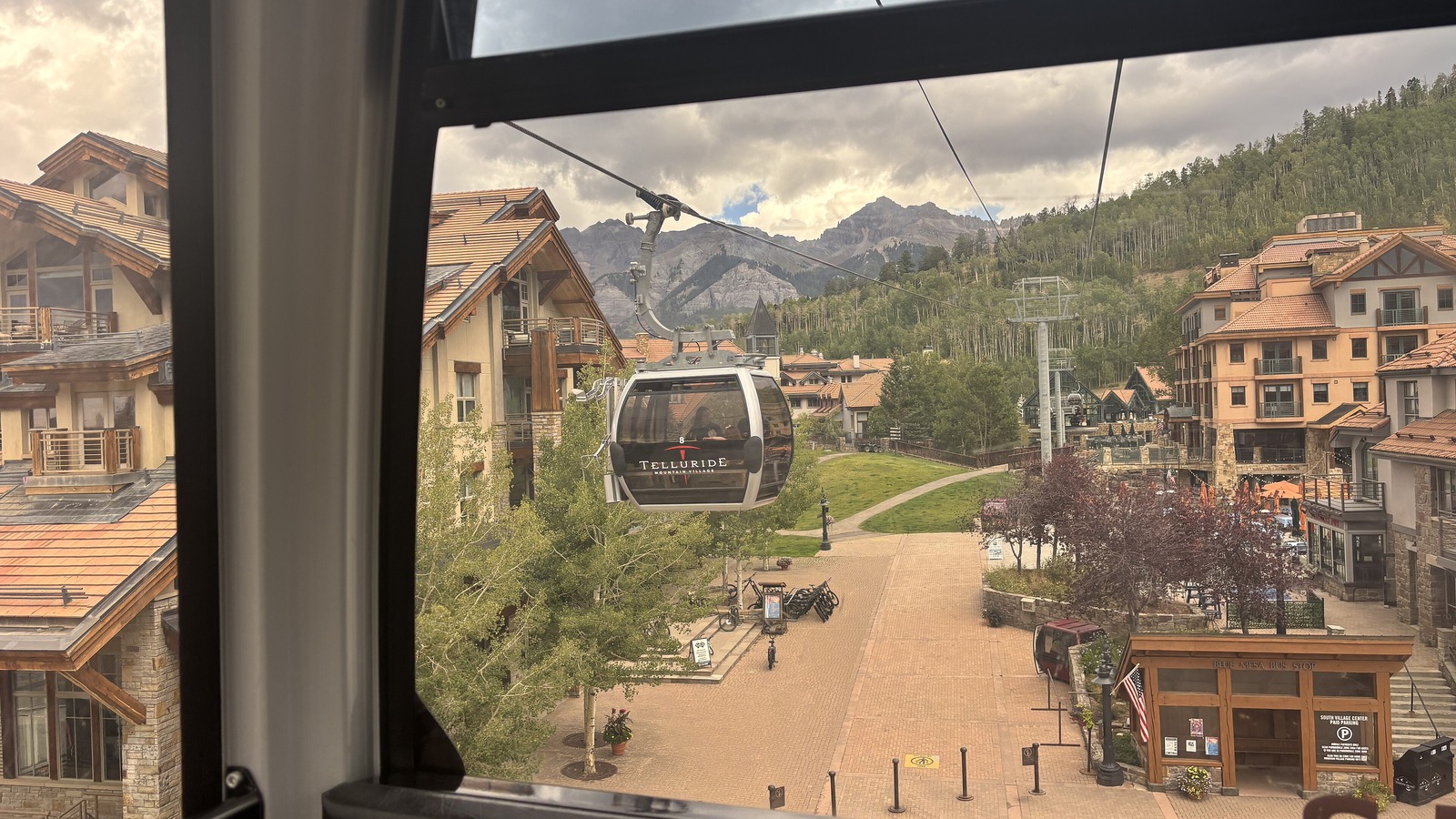Sunny Mountain Village pedestrian plaza in Telluride with mountain scenery