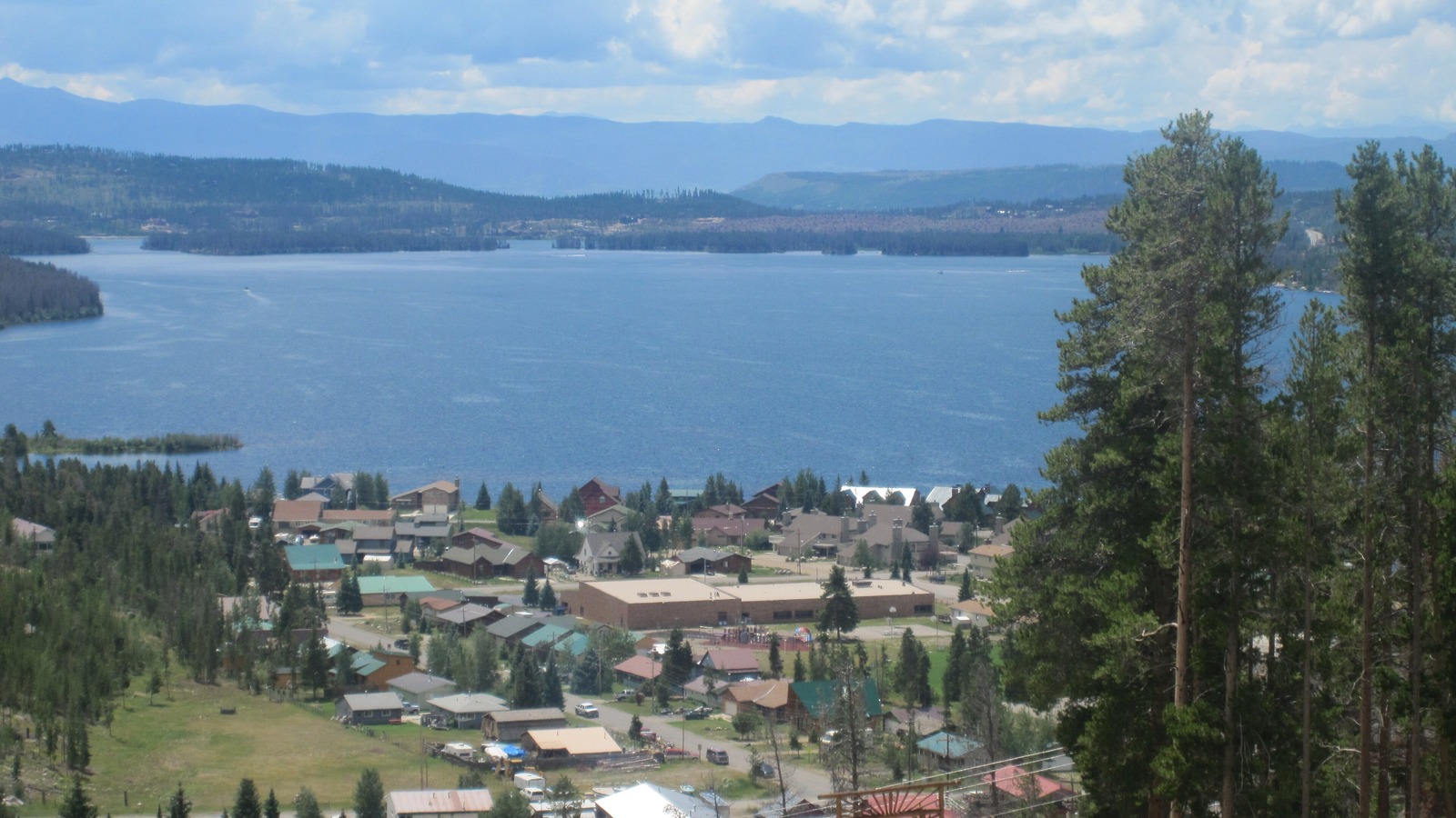 Sunny Grand Lake waterfront with Rocky Mountain National Park peaks