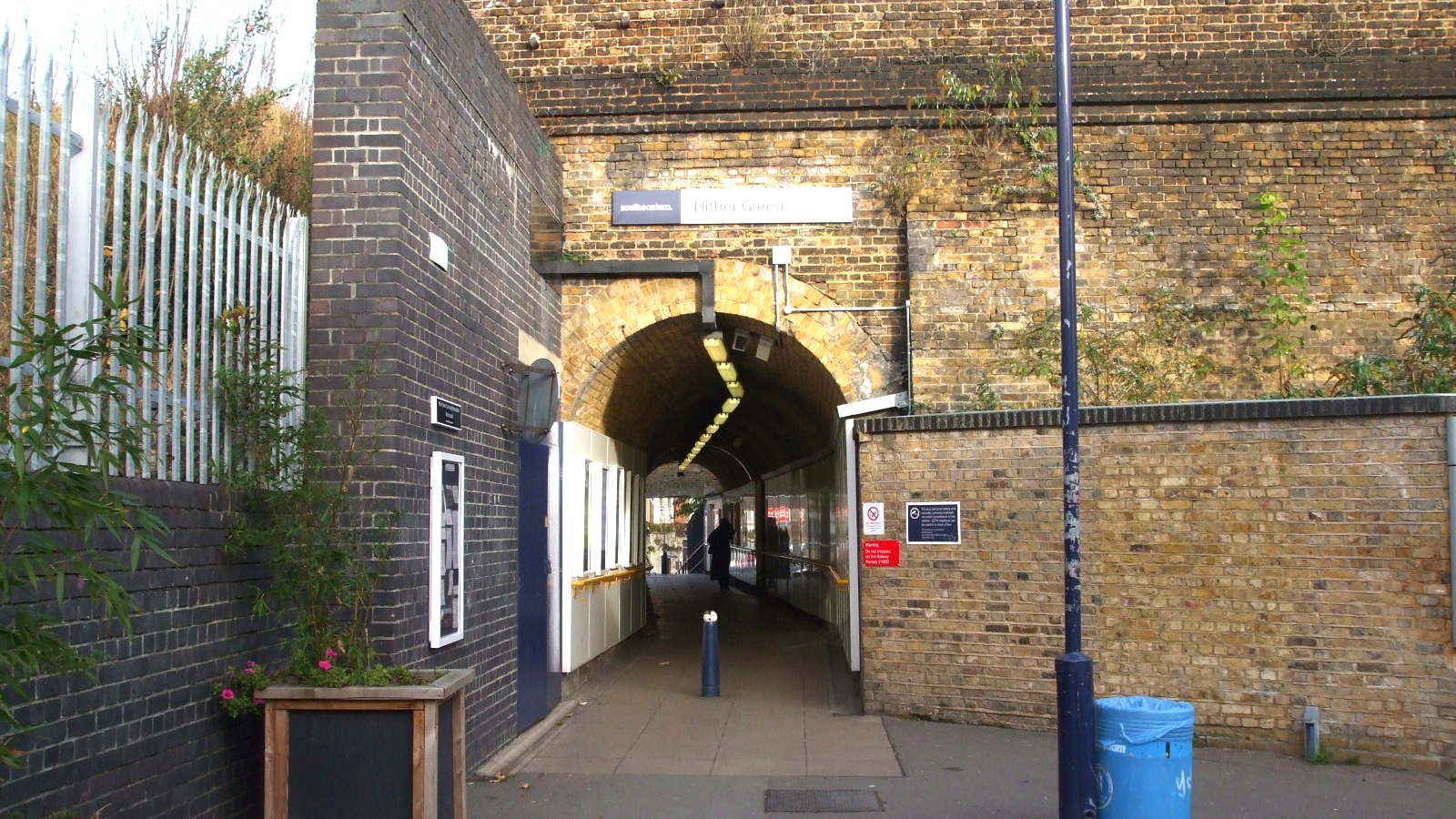 Existing western entrance at Hither Green station, with a Southeastern Hither Green sign over the brick arch