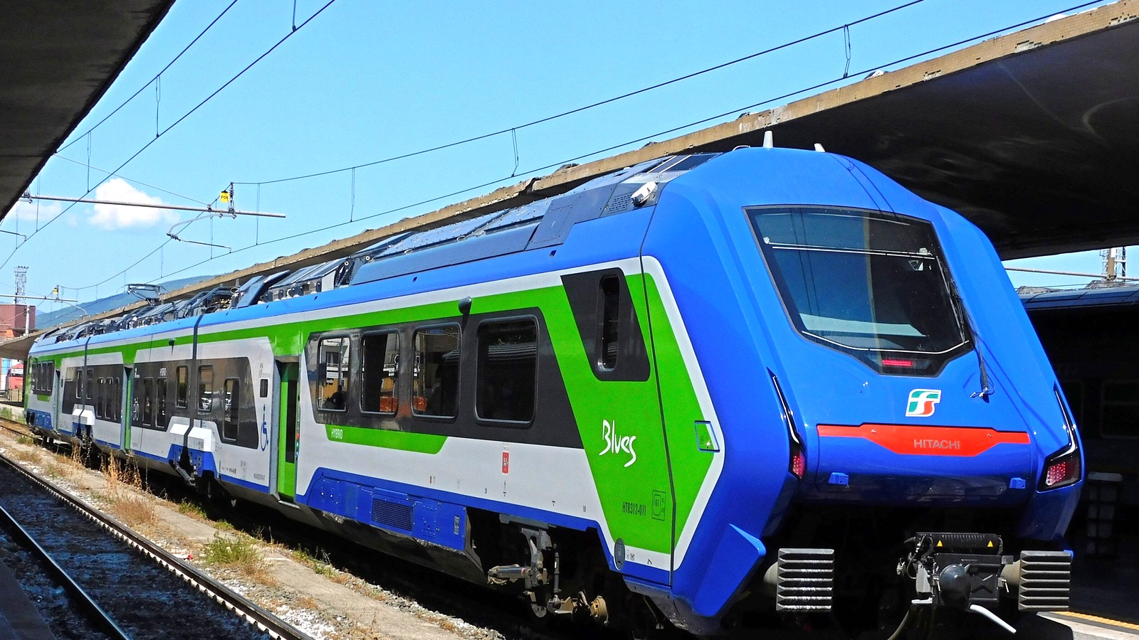 Blue and green Hitachi Blues regional train at a Florence Santa Maria Novella platform in an August 2024 file photo