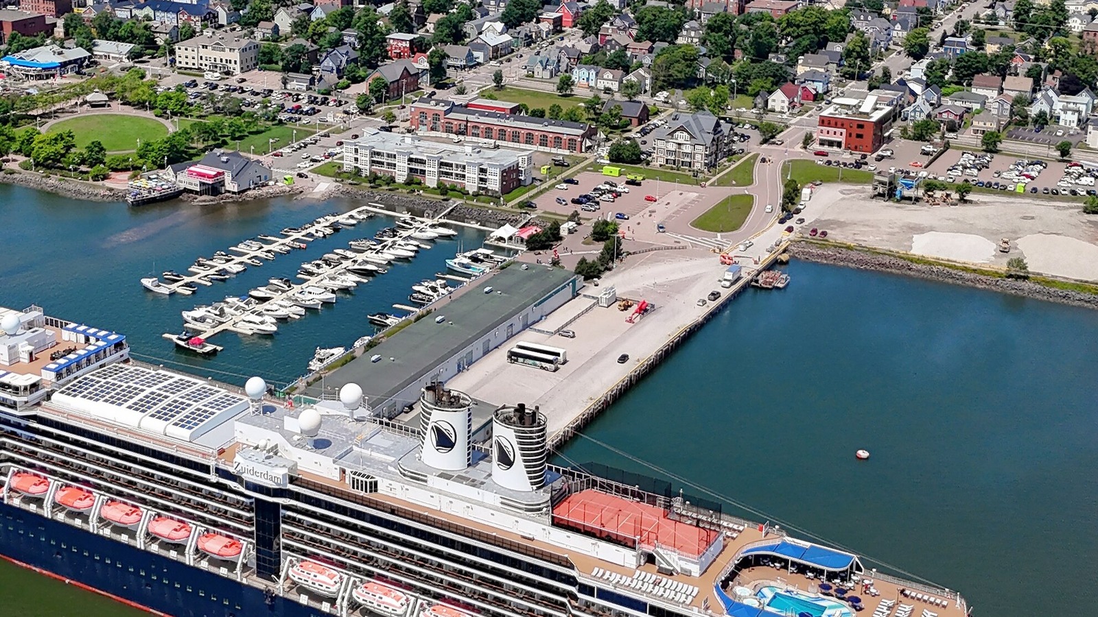 Holland America Line's Zuiderdam docked at a pier in Charlottetown, Prince Edward Island, with its funnels and ship name visible from above