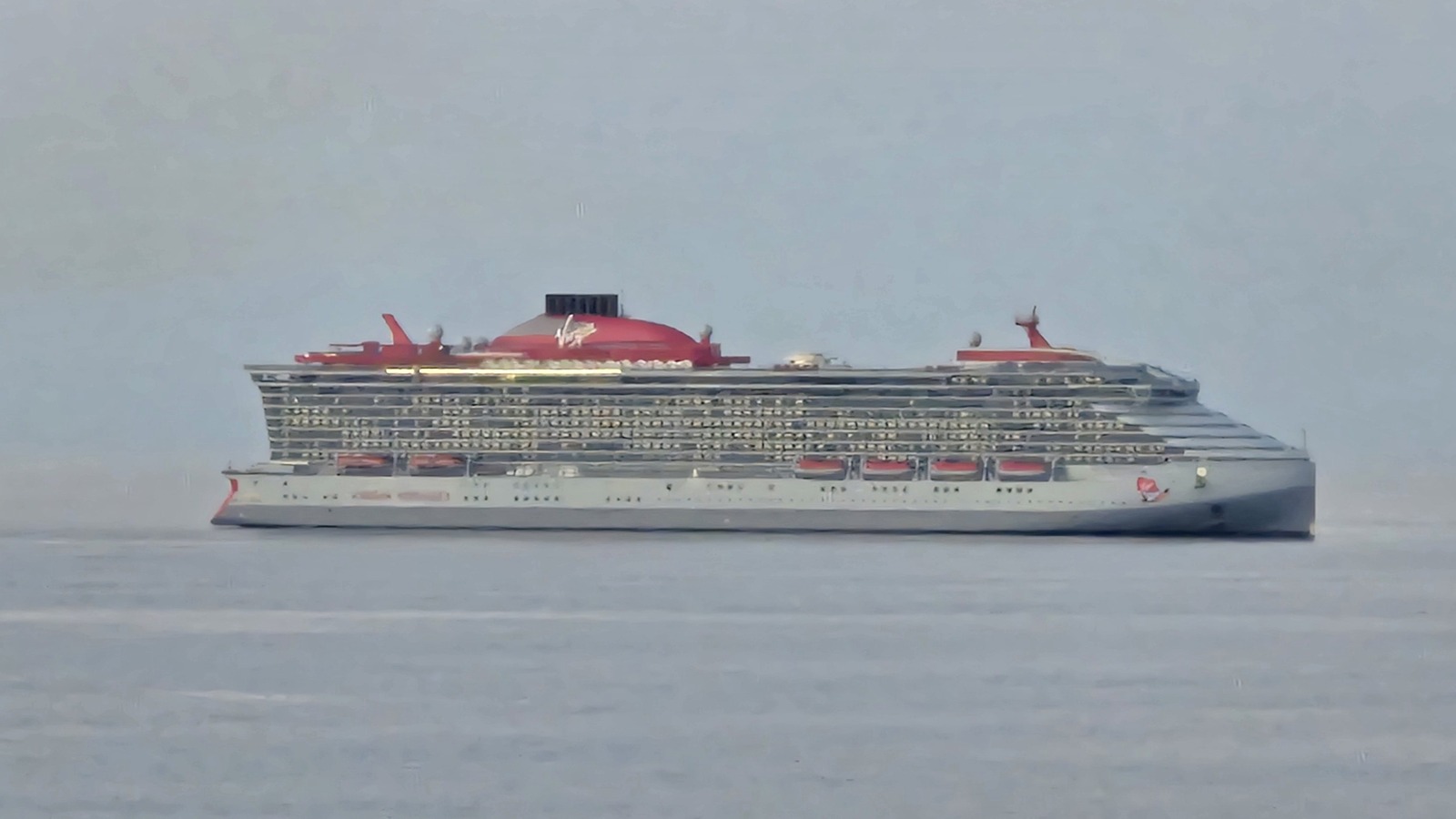 Brilliant Lady cruise ship with red Virgin funnel at sea