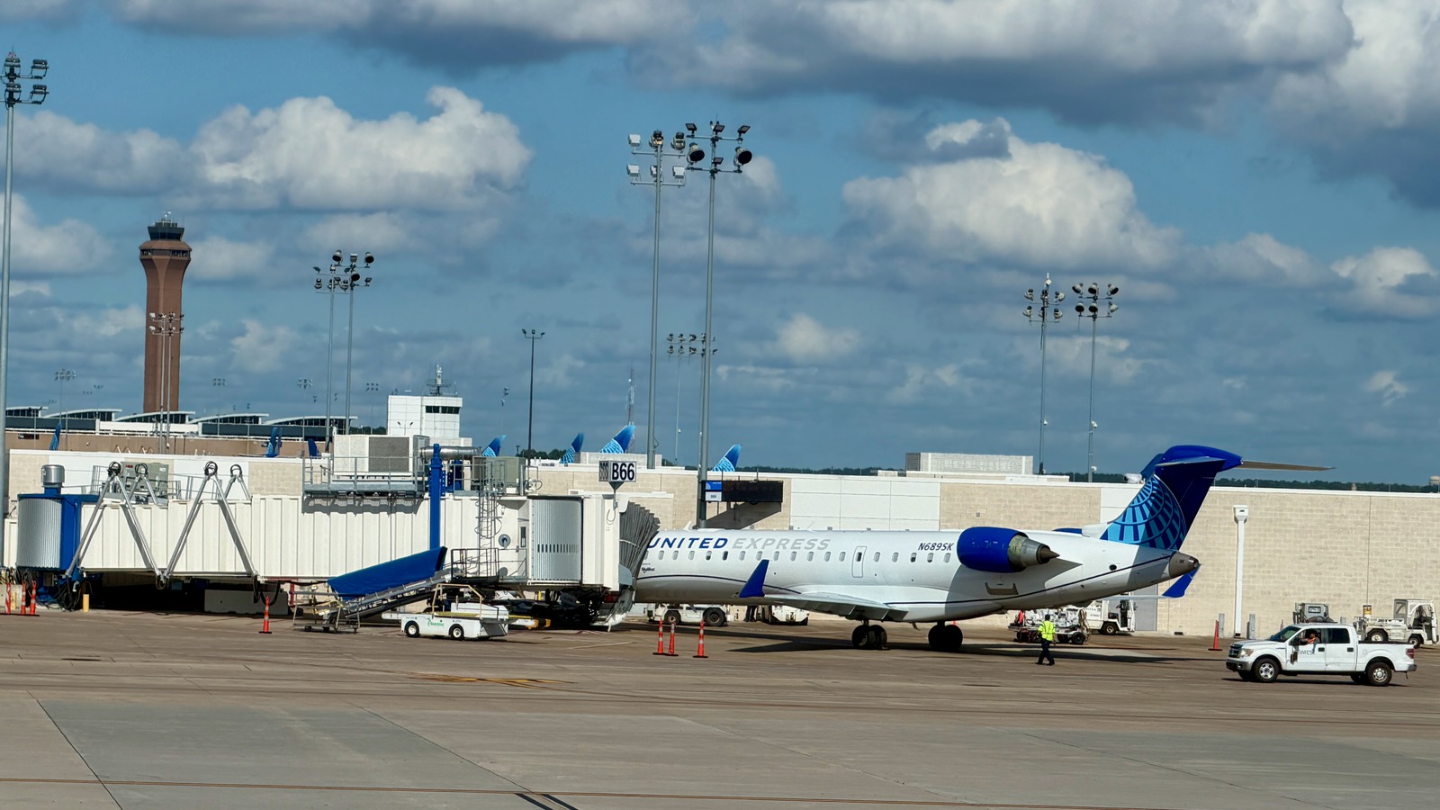 United Express Bombardier CRJ-550 aircraft parked at an airport gate in daylight