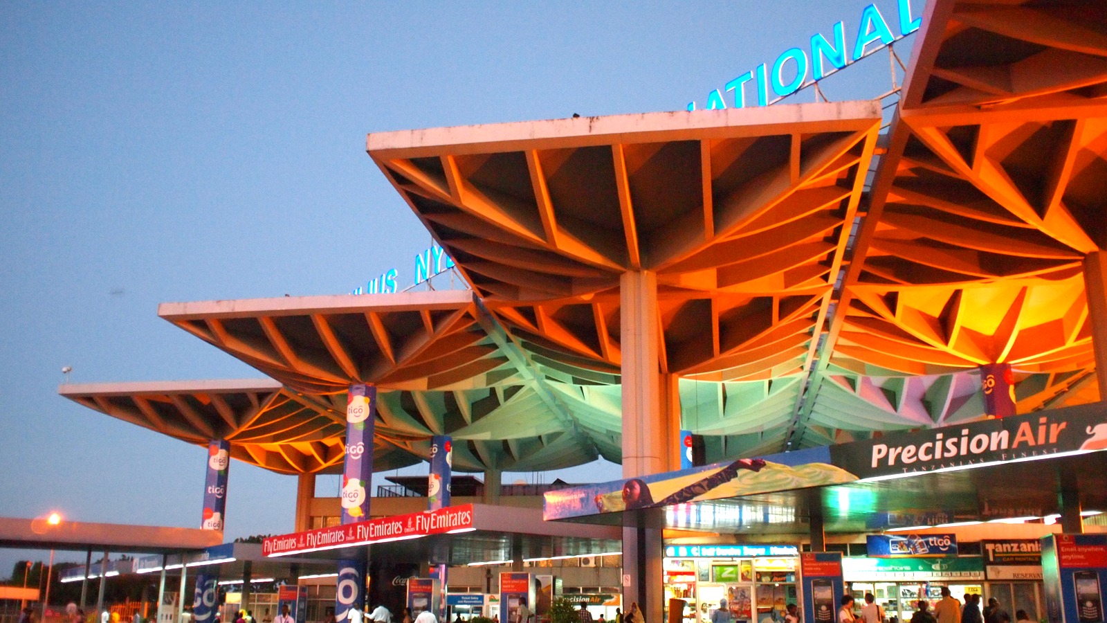 Julius Nyerere International Airport terminal canopy and entrance in Dar es Salaam, Tanzania, at dusk