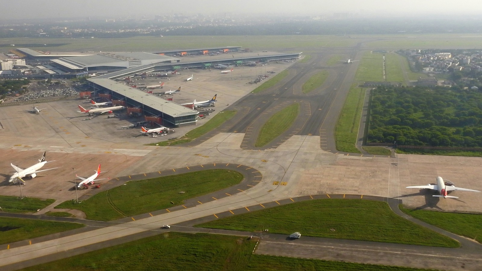 Aerial view of Indira Gandhi International Airport Terminal 3 piers, taxiways, and parked aircraft in New Delhi