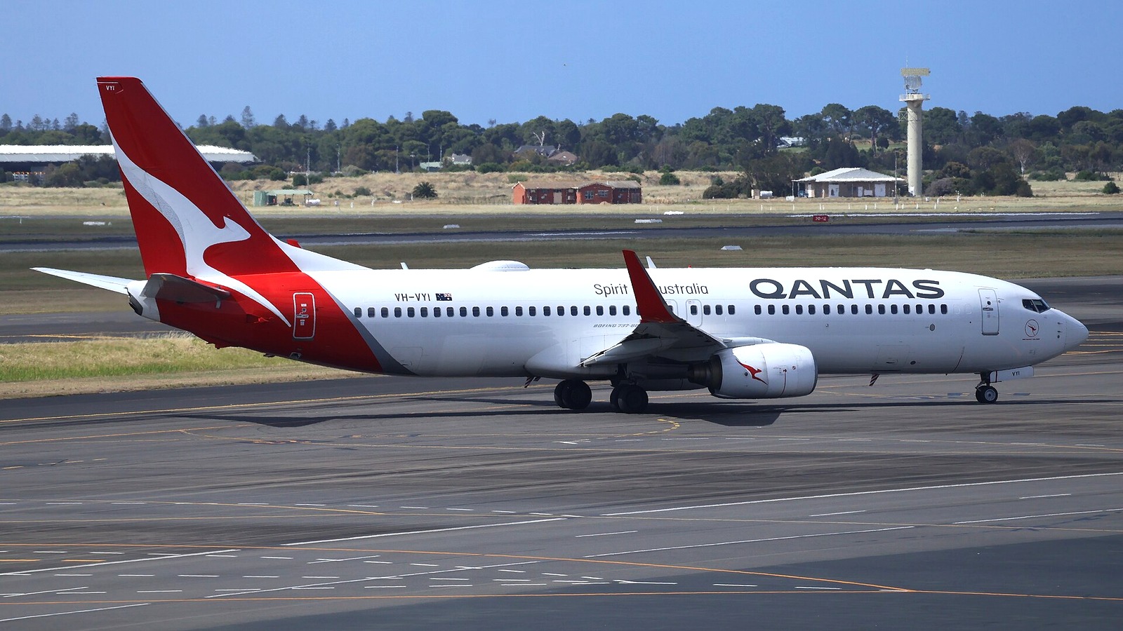 A Qantas Boeing 737-800 taxiing at Adelaide Airport on a sunny day