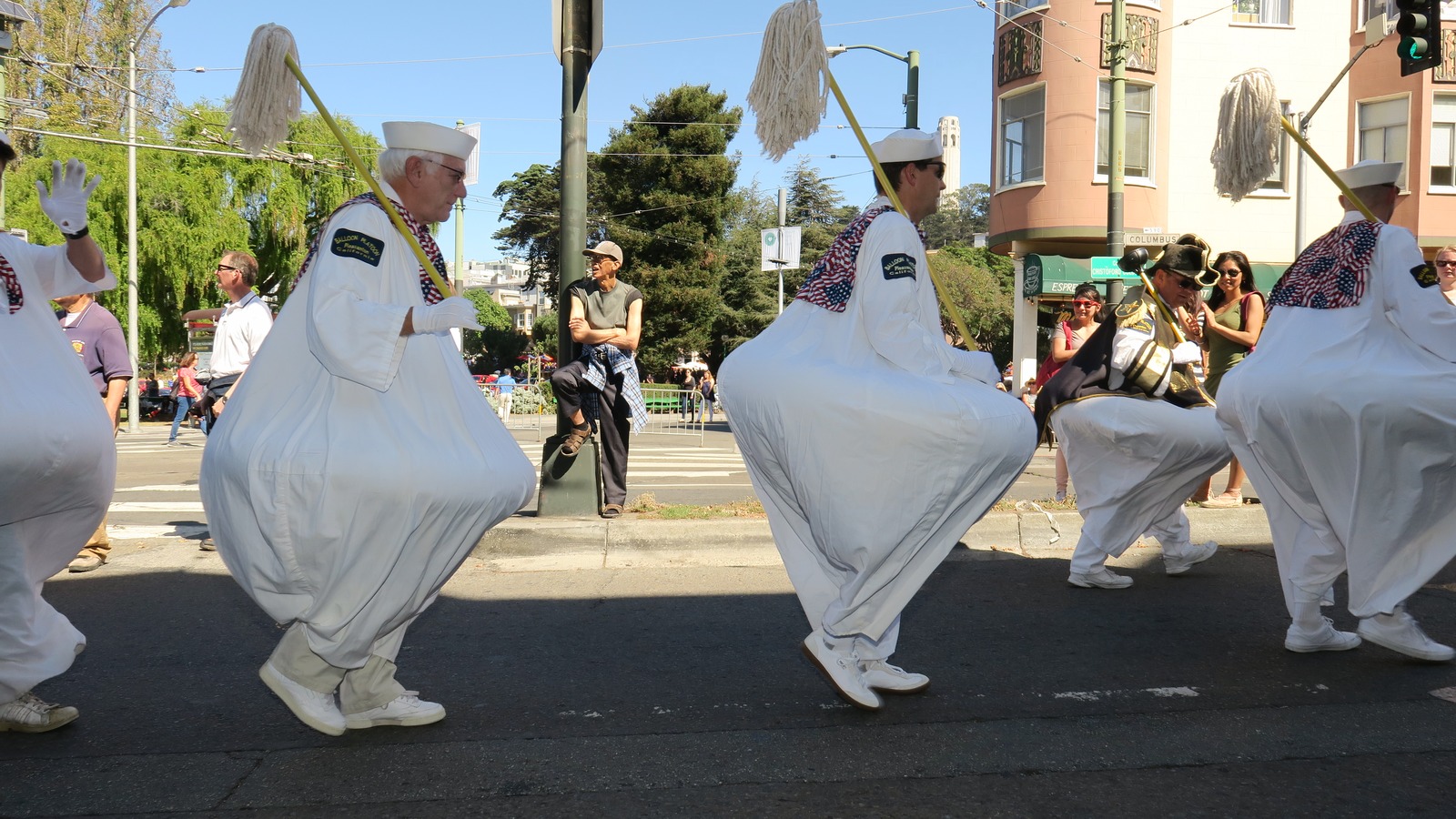 Adult marchers in white costumes on a San Francisco street during the 2017 Italian Heritage Parade, not the October 2026 closure