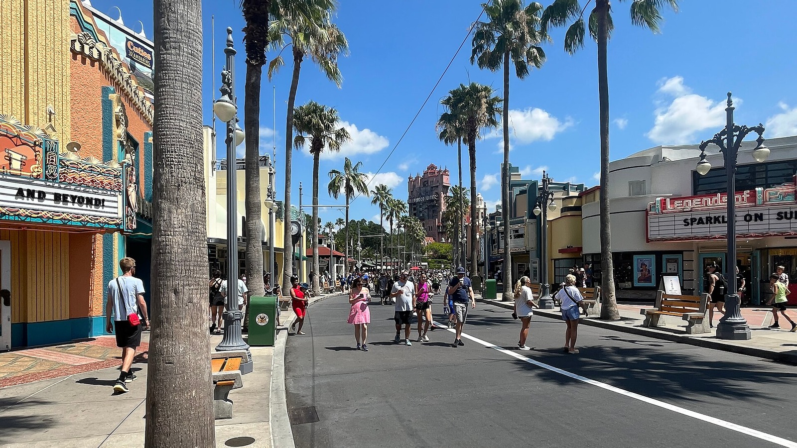 Sunset Boulevard at Disney's Hollywood Studios by day with palm trees and the Hollywood Tower Hotel in the distance