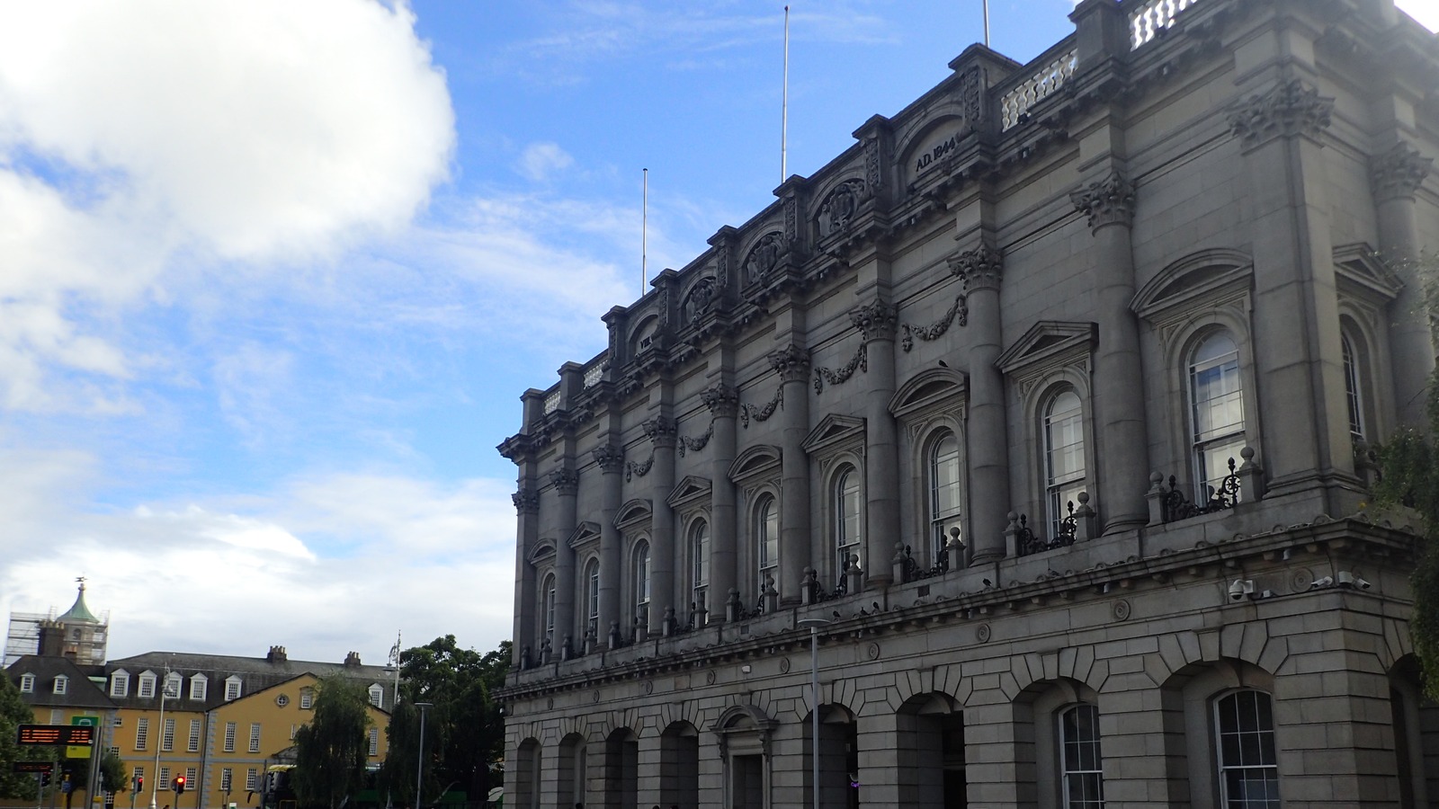 Stone exterior of Heuston Station in Dublin, the Irish Rail terminus for Dublin-Cork trains, photographed on a clear day.
