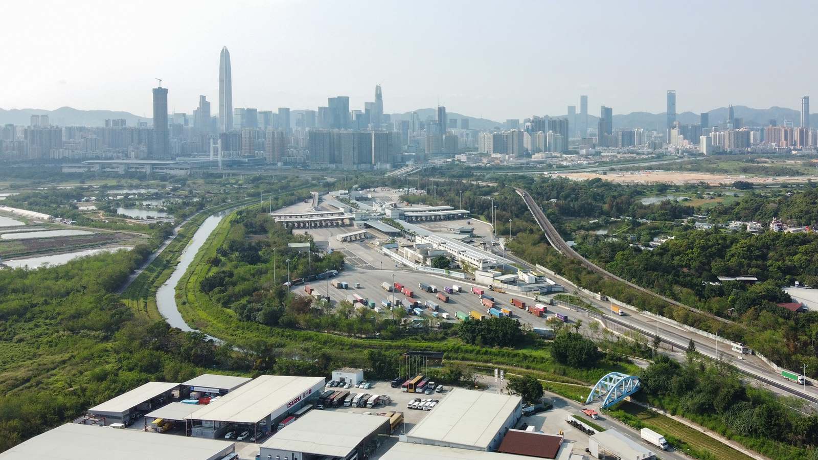 Aerial view of the Lok Ma Chau control point area with the Shenzhen skyline beyond the border river