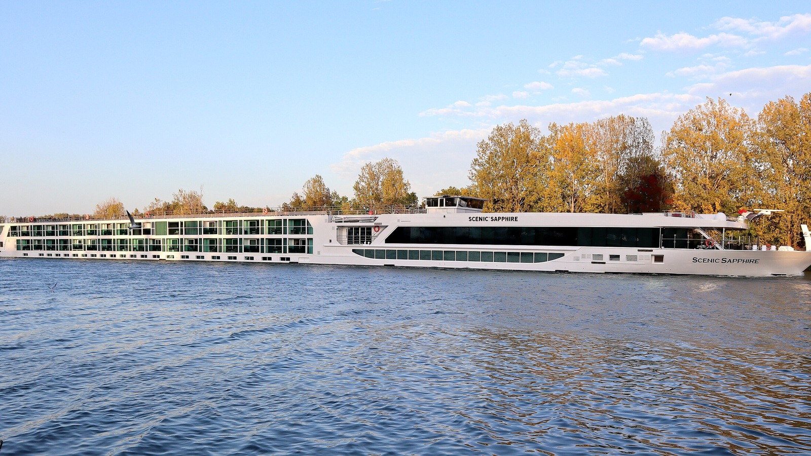 Scenic Sapphire river cruise ship sailing on the Saone River at Tournus, France, in autumn