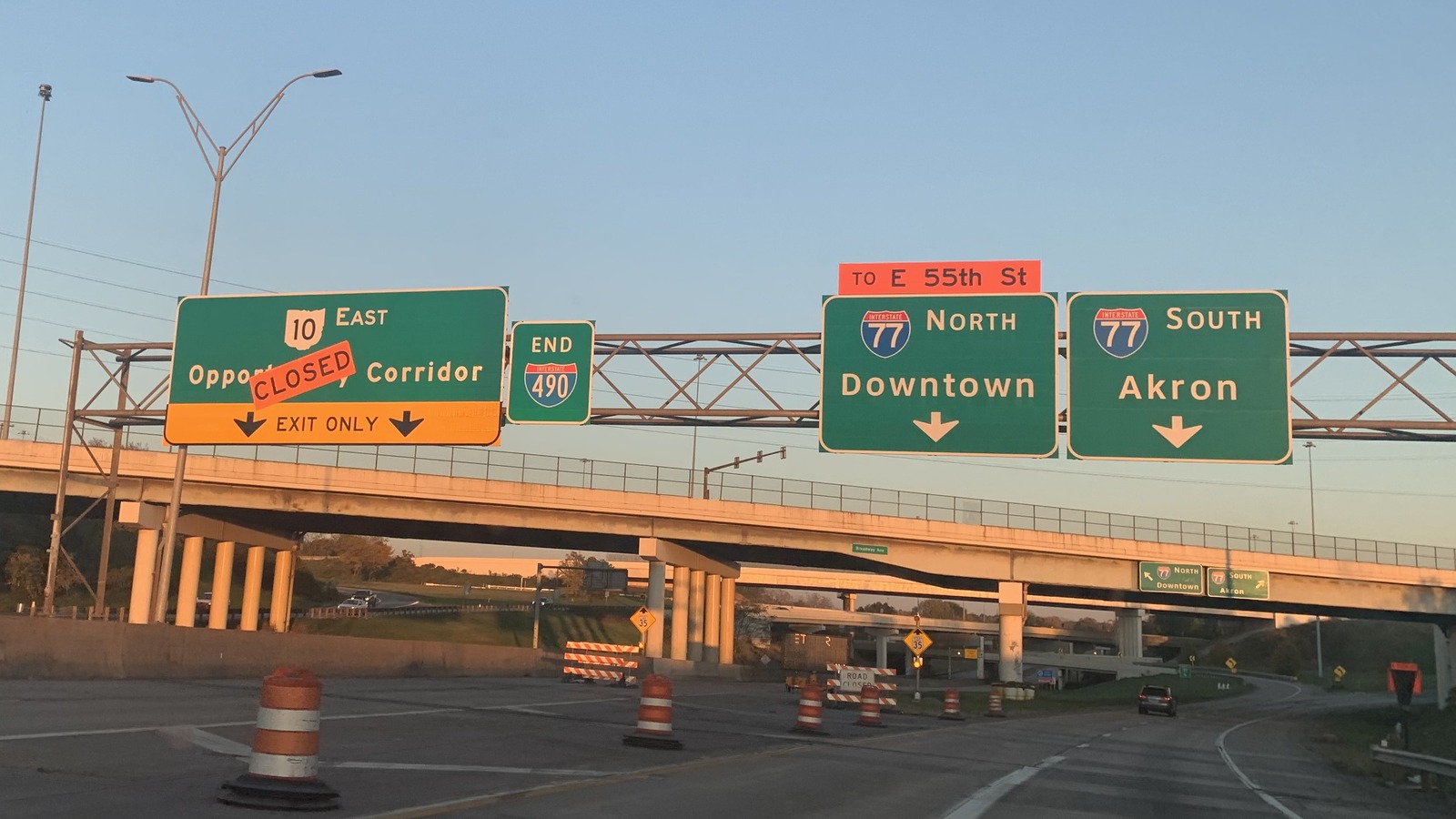 Interstate 77 north and south destination signs at Cleveland I-490 interchange with Broadway Avenue overpass