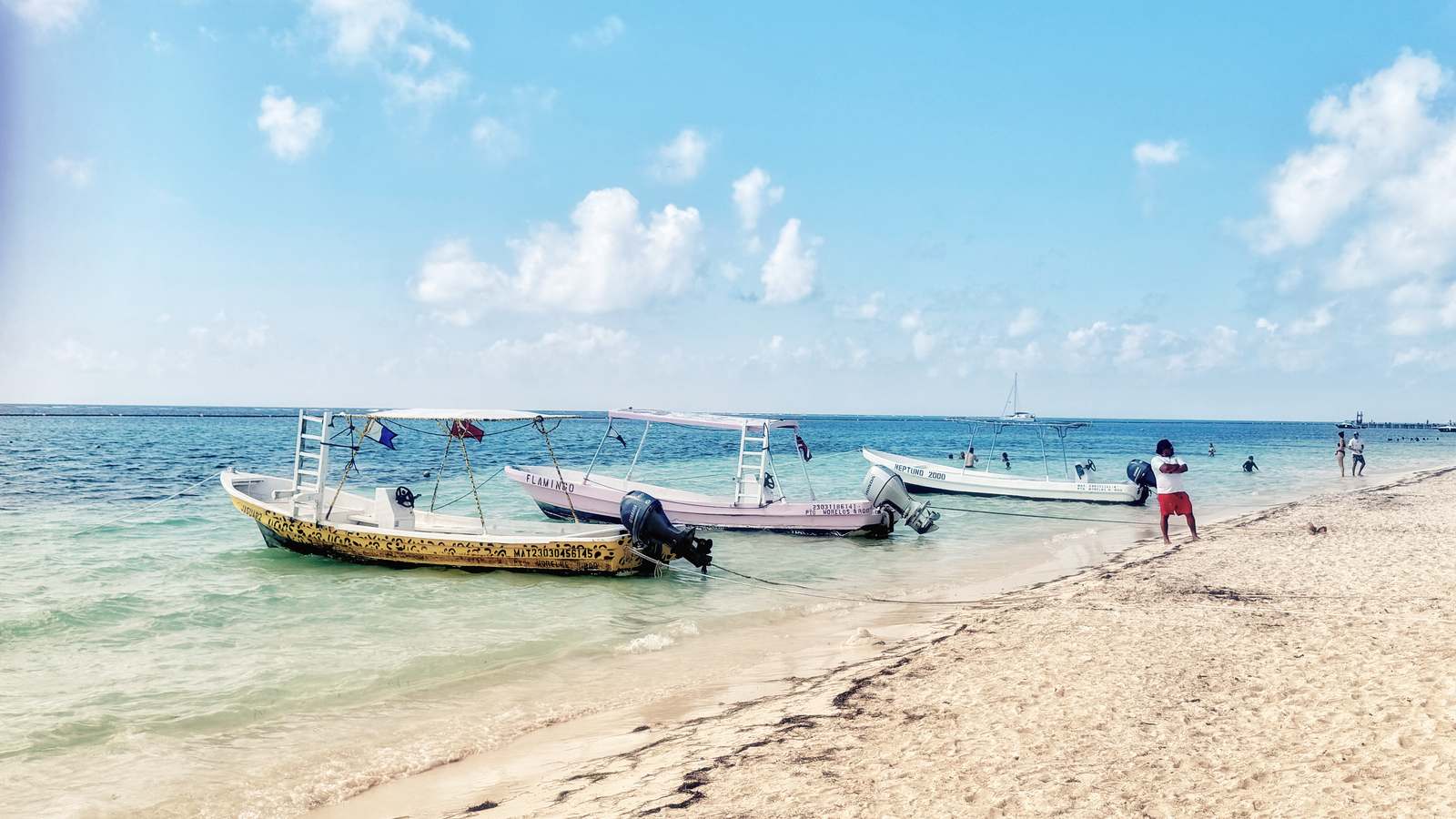 Small boats moored off the beach at Puerto Morelos on Mexico's Riviera Maya