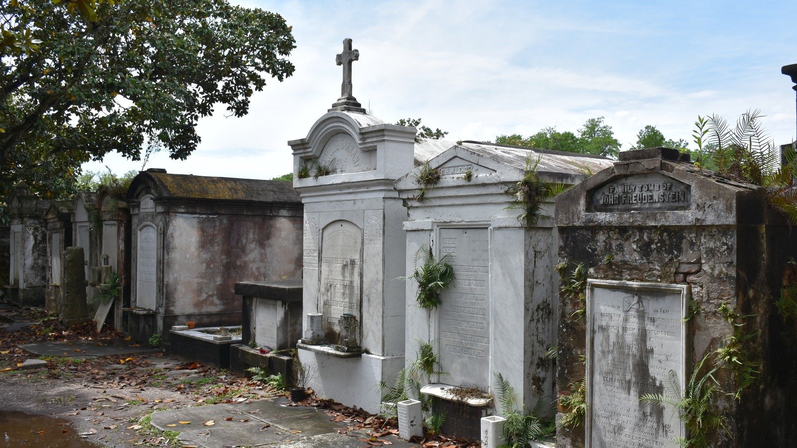 Above-ground family tombs along a walkway at Lafayette Cemetery No. 1 in the Garden District of New Orleans