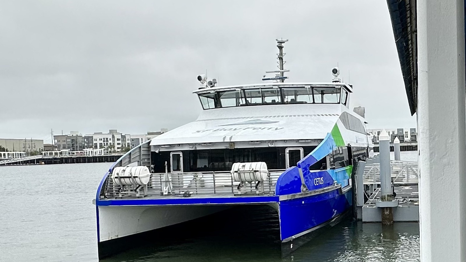 An SF Bay Ferry catamaran named Cetus docked at the Oakland Ferry Terminal