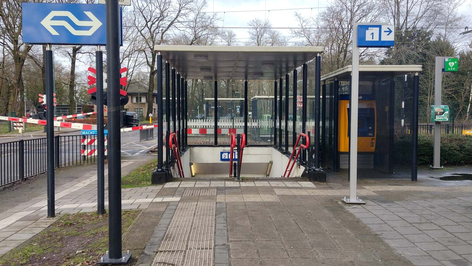 Entrance to the platforms at Wolfheze station beside the level crossing barriers on the Arnhem to Ede line