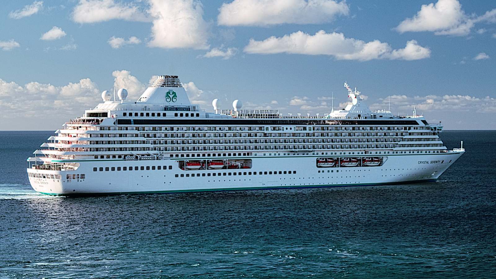 Cruise ship Crystal Serenity under way at sea under a partly cloudy sky