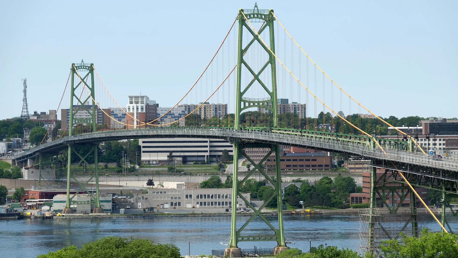 Green steel towers and deck of the Macdonald suspension bridge over Halifax Harbour
