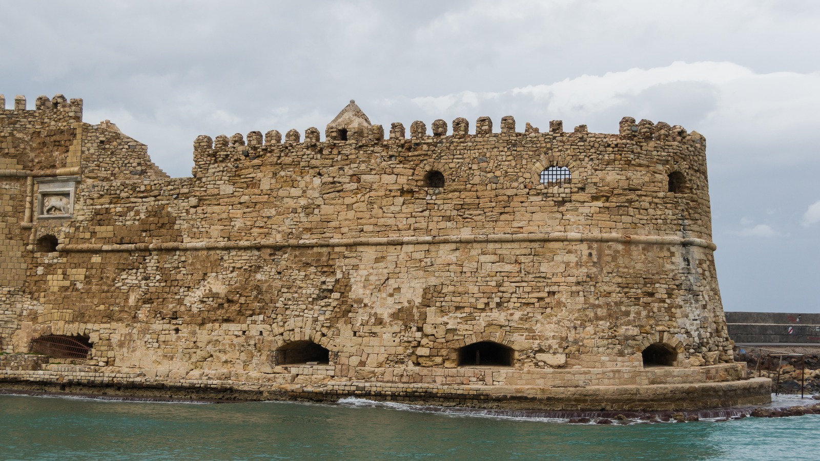 The Venetian Koules fortress on the old harbor at Heraklion, Crete, under a cloudy sky