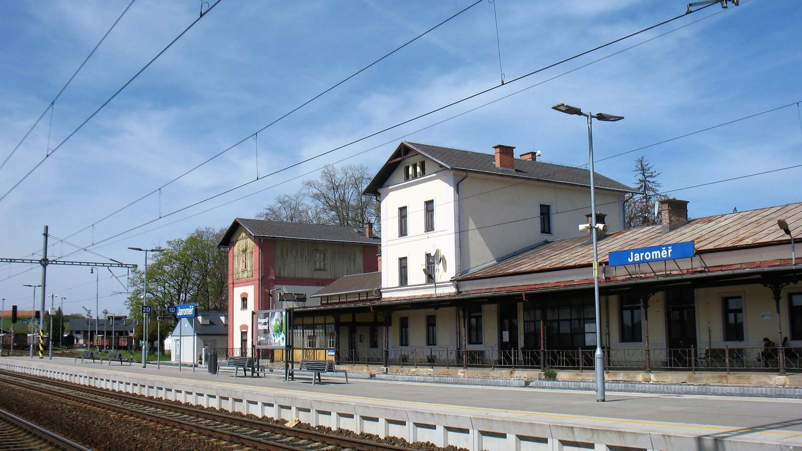 Platform and station building at Jaroměř with the station name sign