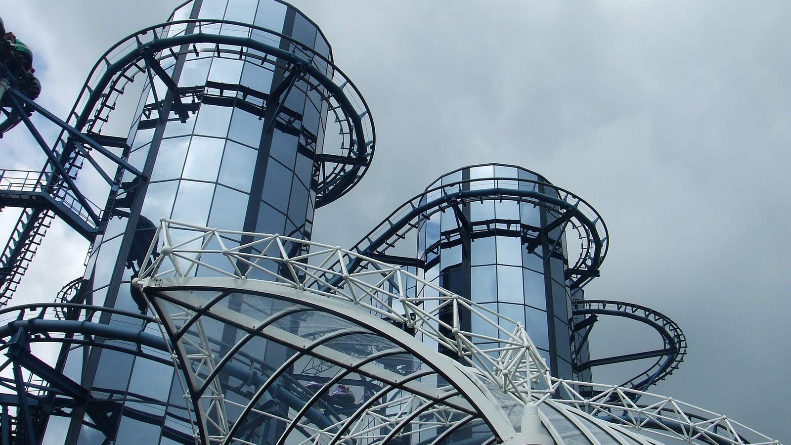 Euro-Mir spinning coaster at Europa-Park with its two mirrored towers and track under a cloudy sky