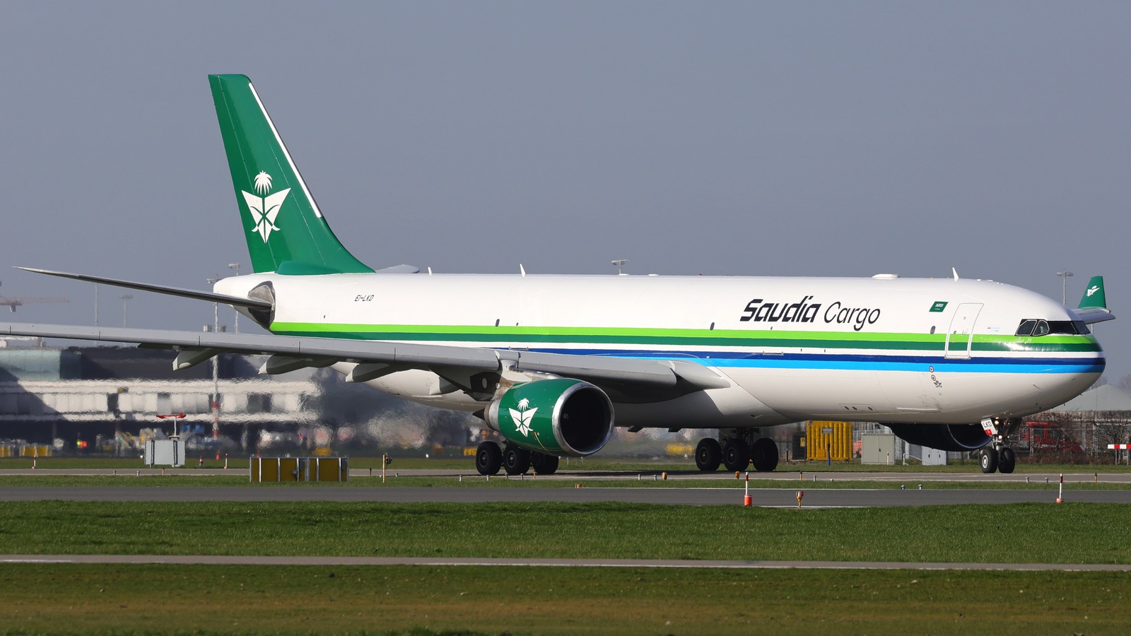 Saudia Cargo Airbus A330 taxiing on a runway, photographed in profile against a clear sky.